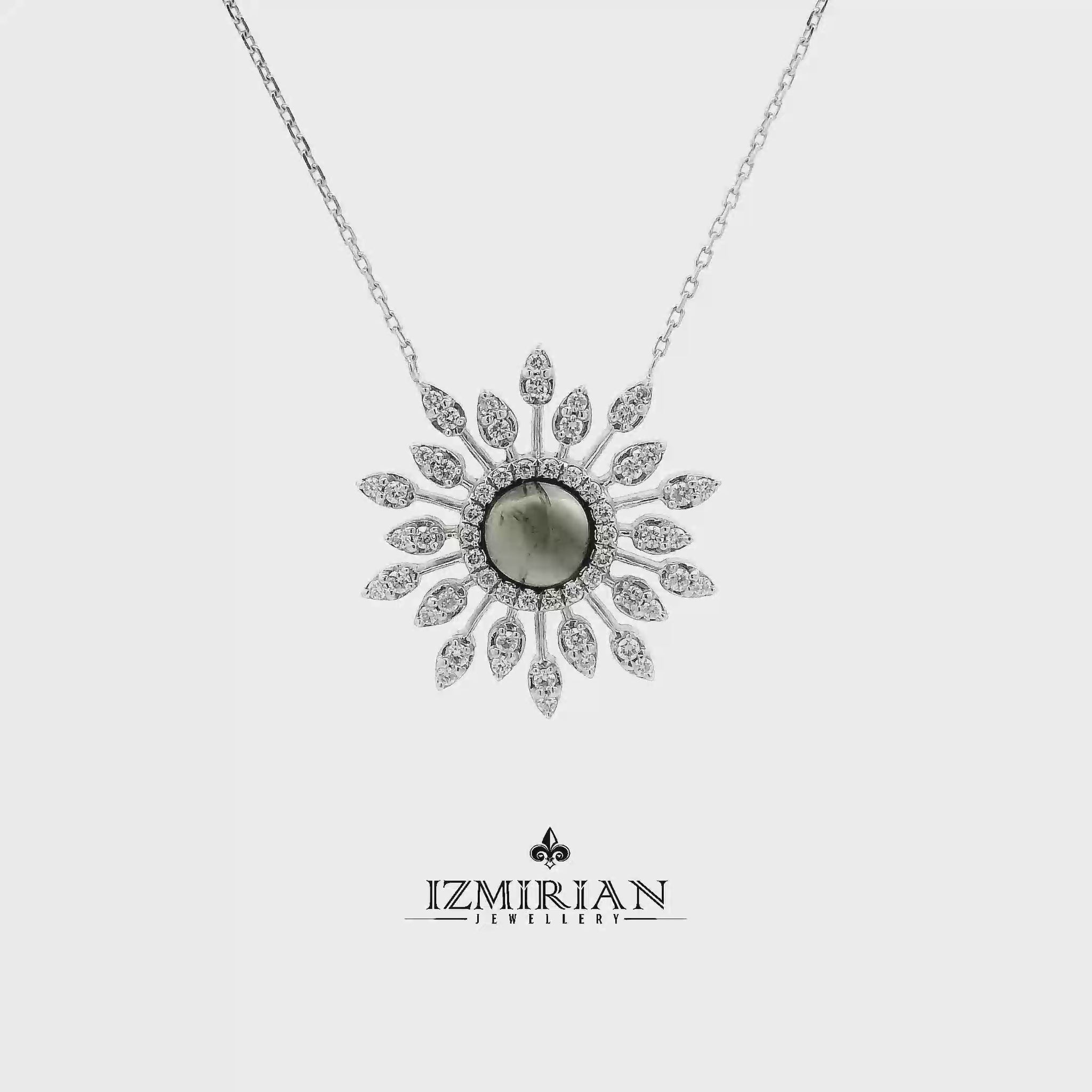 Grey gemstone and diamond sunburst necklace in white gold shown in motion