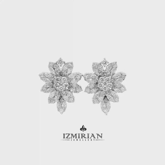 Diamond flower cluster stud earrings in white gold shown in motion