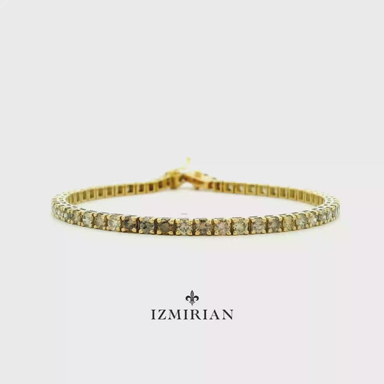 Champagne diamond tennis bracelet in yellow gold shown in motion