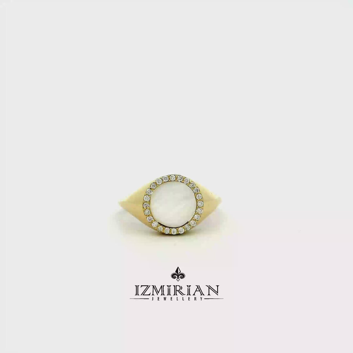 Mother of pearl halo ring in yellow gold shown in motion