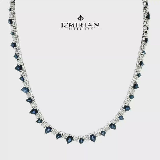 Blue sapphire and diamond drop tennis necklace in white gold shown in motion