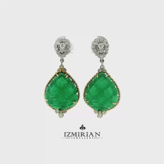 Carved emerald drop earrings in yellow and white gold shown in motion