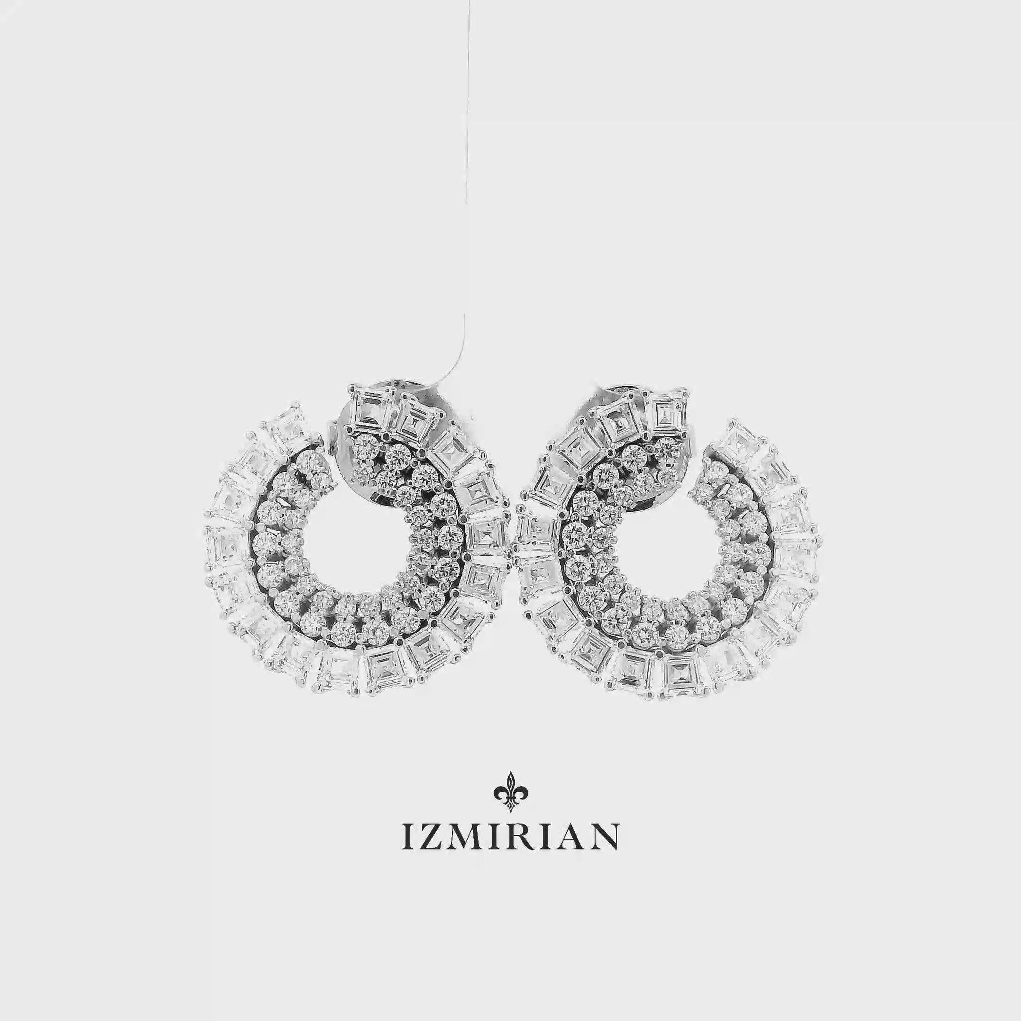 Diamond baguette hoop earrings in white gold shown in motion