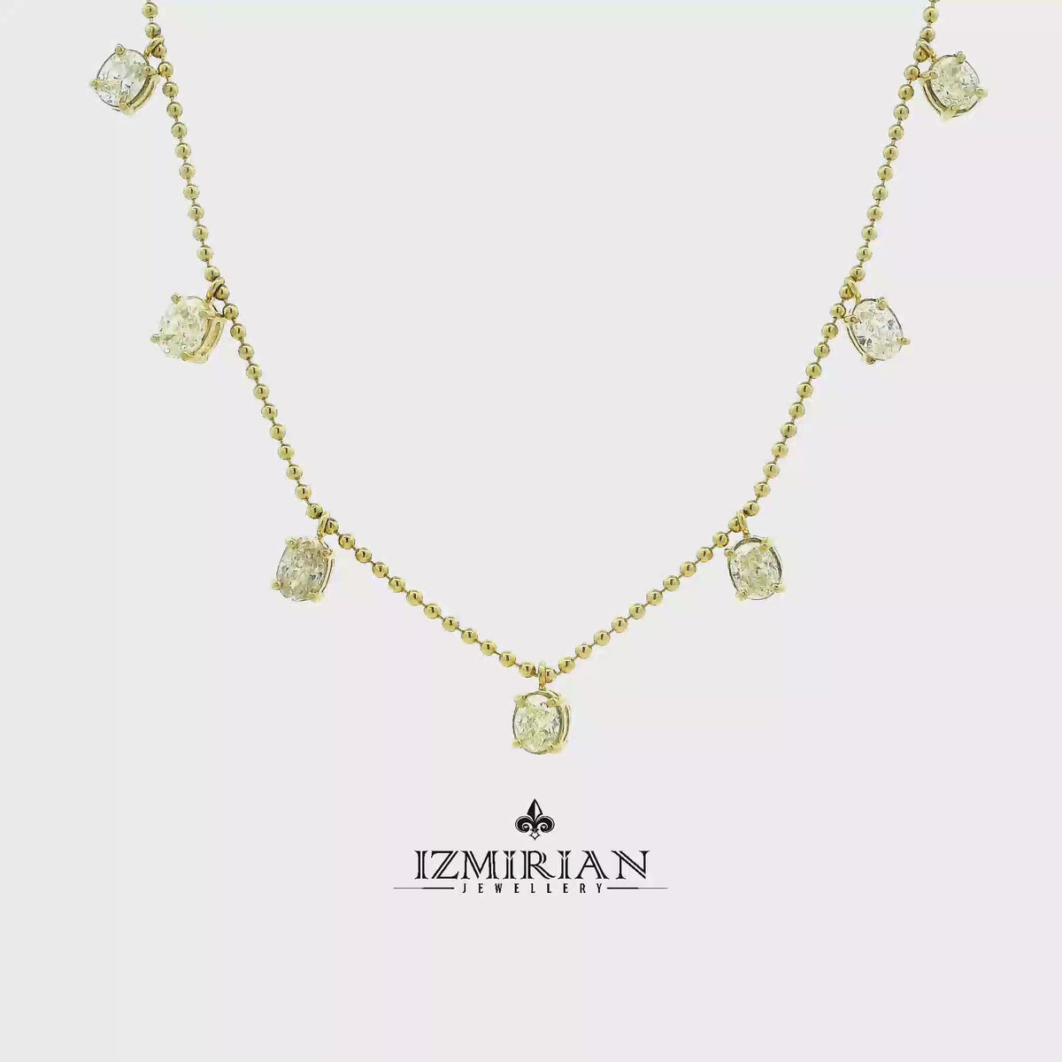 Diamond drop station necklace in yellow gold shown in motion