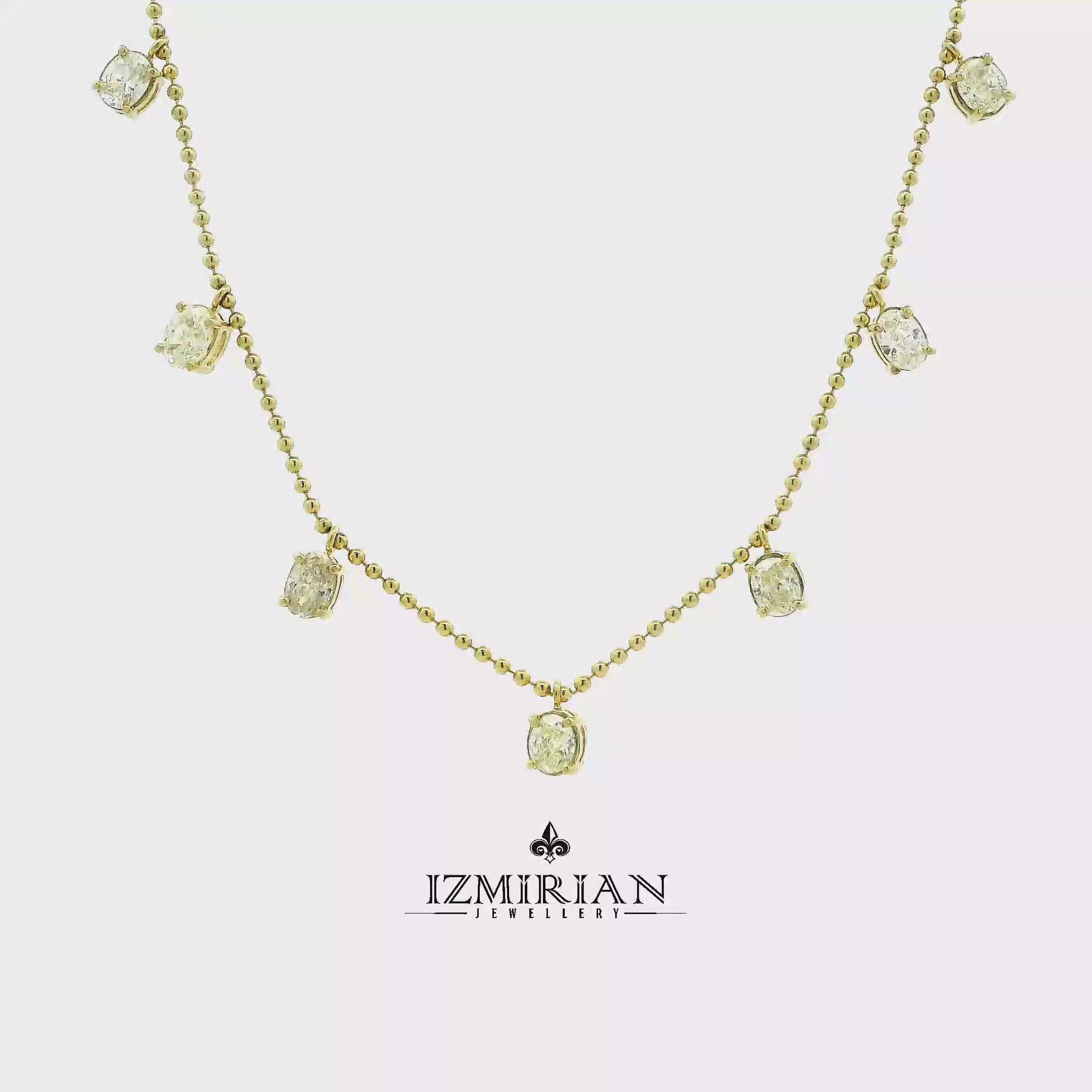 Diamond drop station necklace in yellow gold shown in motion