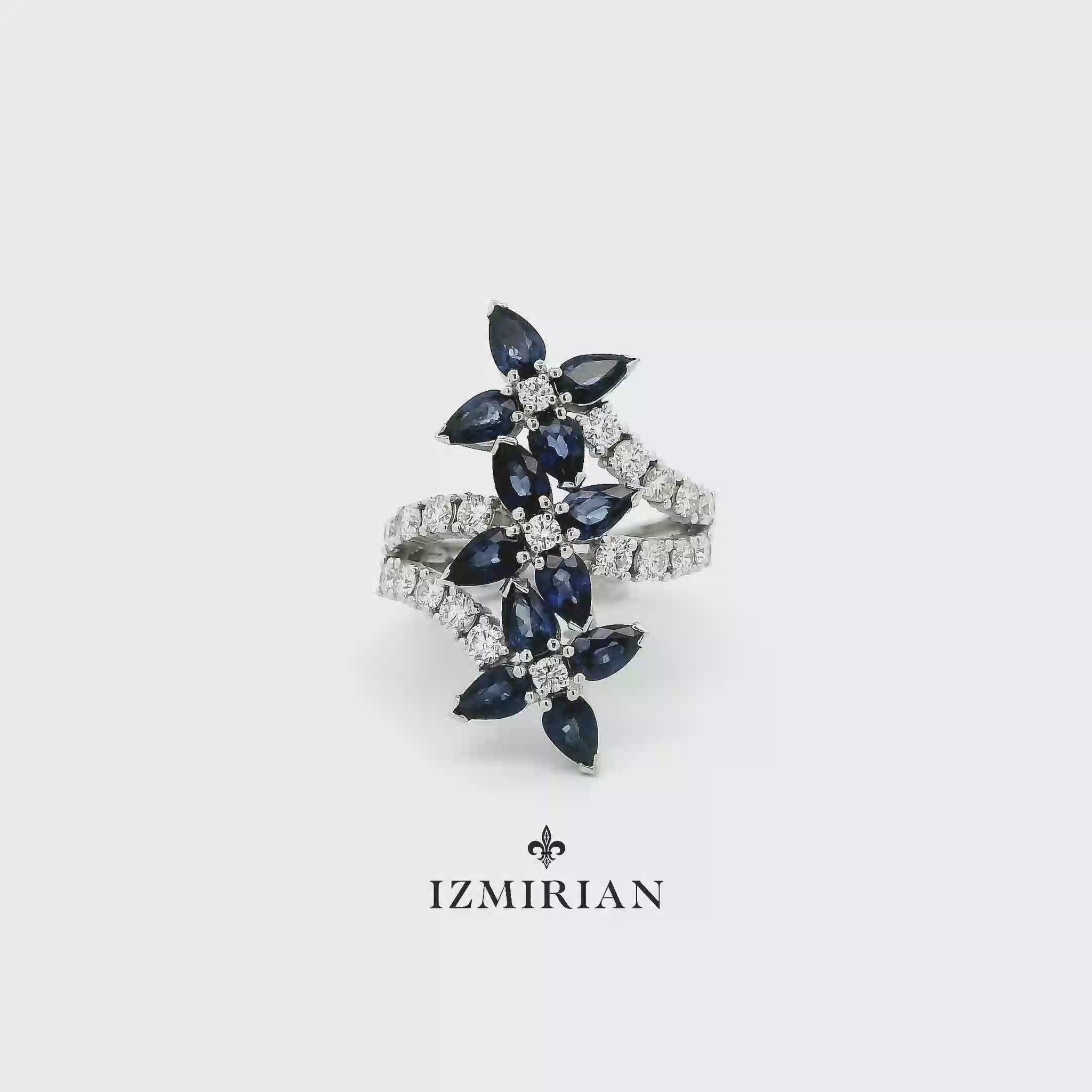 Sapphire floral open ring in white gold shown in motion