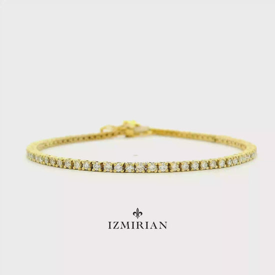 Diamond tennis bracelet in yellow gold shown in motion