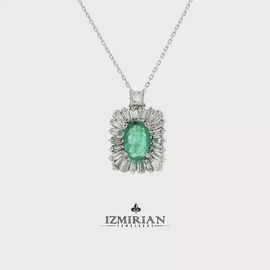 Emerald and diamond halo pendant in white gold shown in motion
