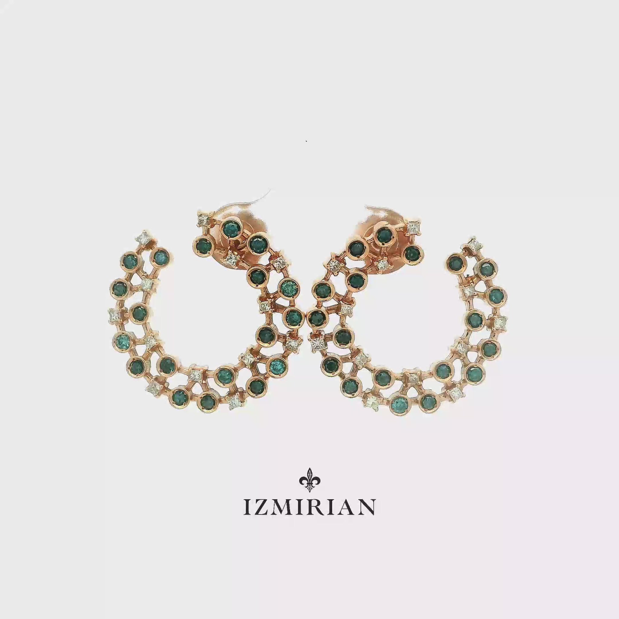 Emerald and diamond open hoop earrings in rose gold shown in motion