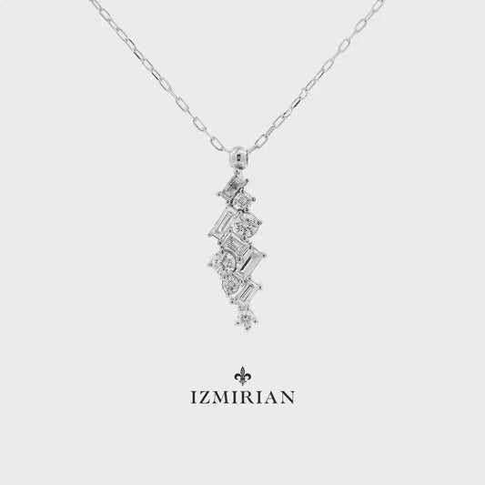 Vertical diamond cluster pendant necklace in white gold shown in motion