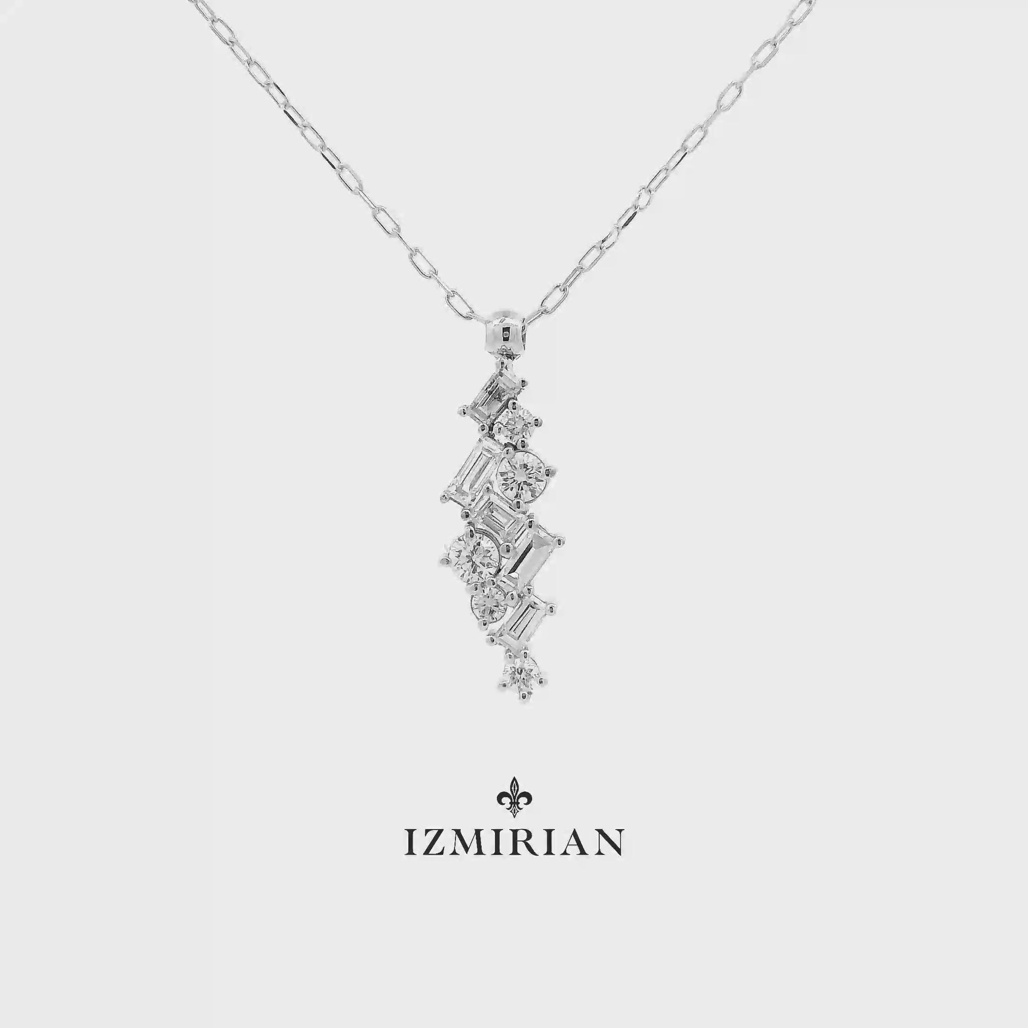 Vertical diamond cluster pendant necklace in white gold shown in motion