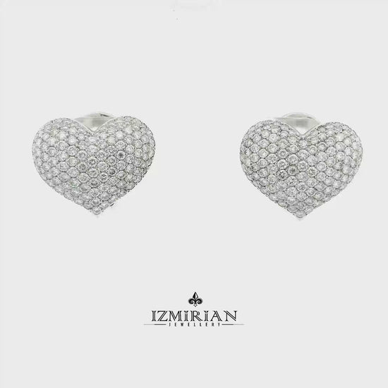 Pavé diamond heart earrings in white gold shown in motion