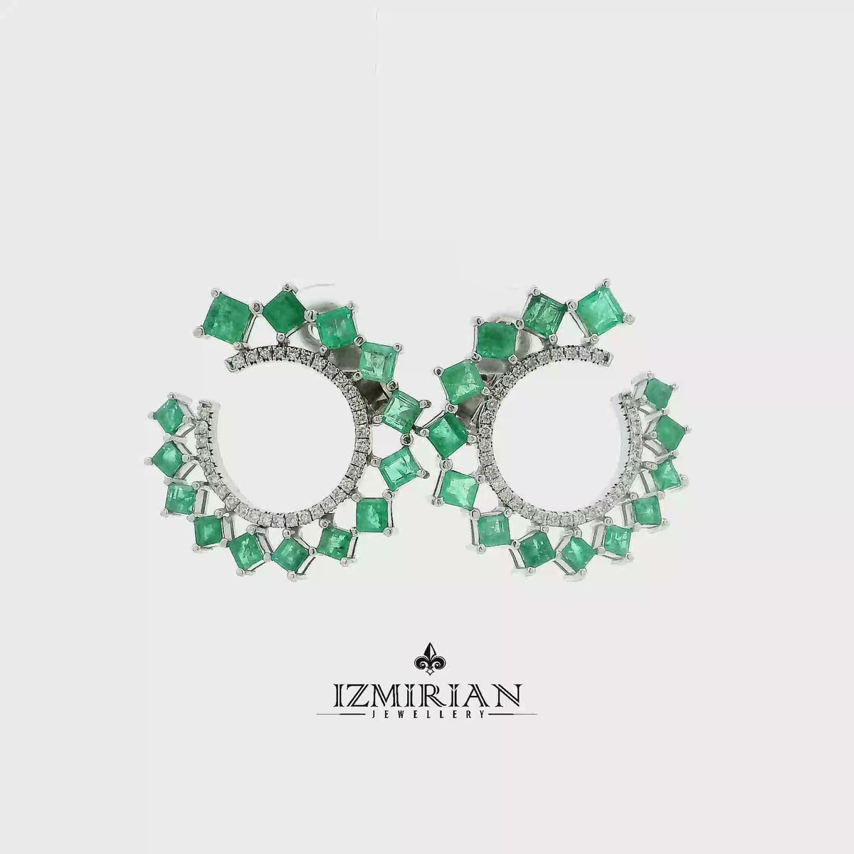 Emerald crown hoop earrings in white gold shown in motion