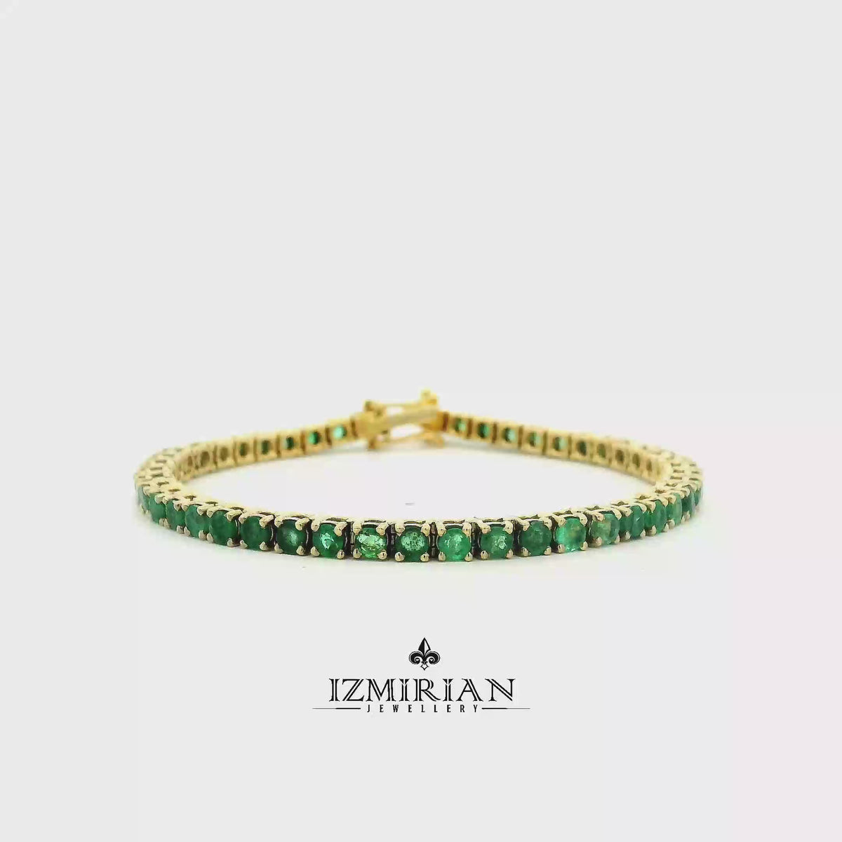 
Emerald tennis bracelet in yellow gold shown in motion