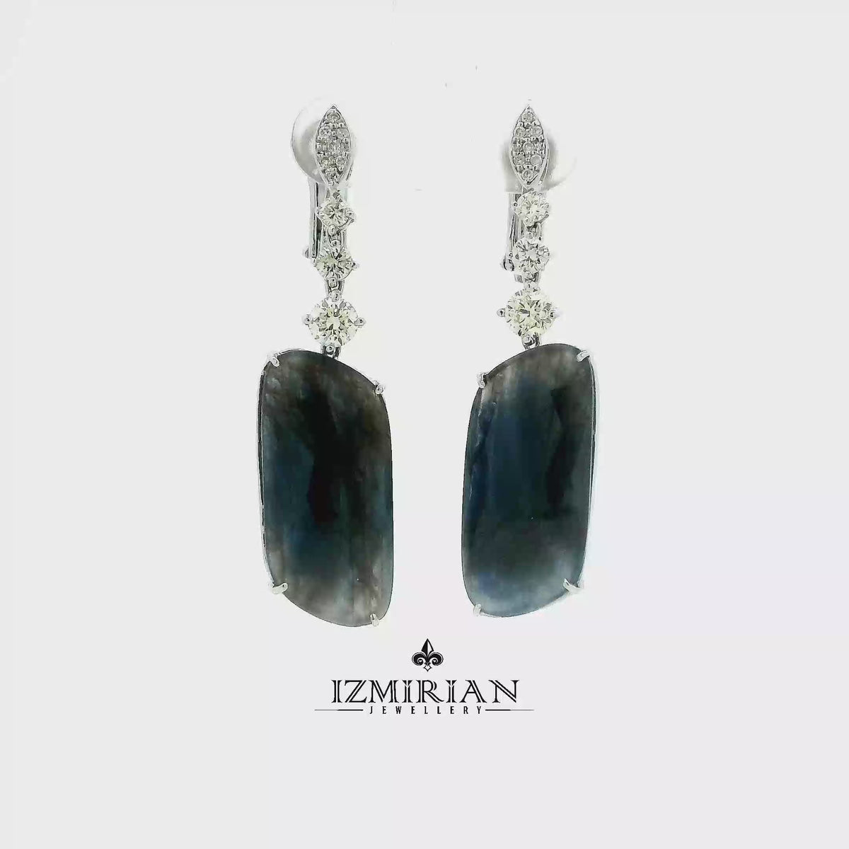 sapphire and diamond drop earrings in white gold shown in motion