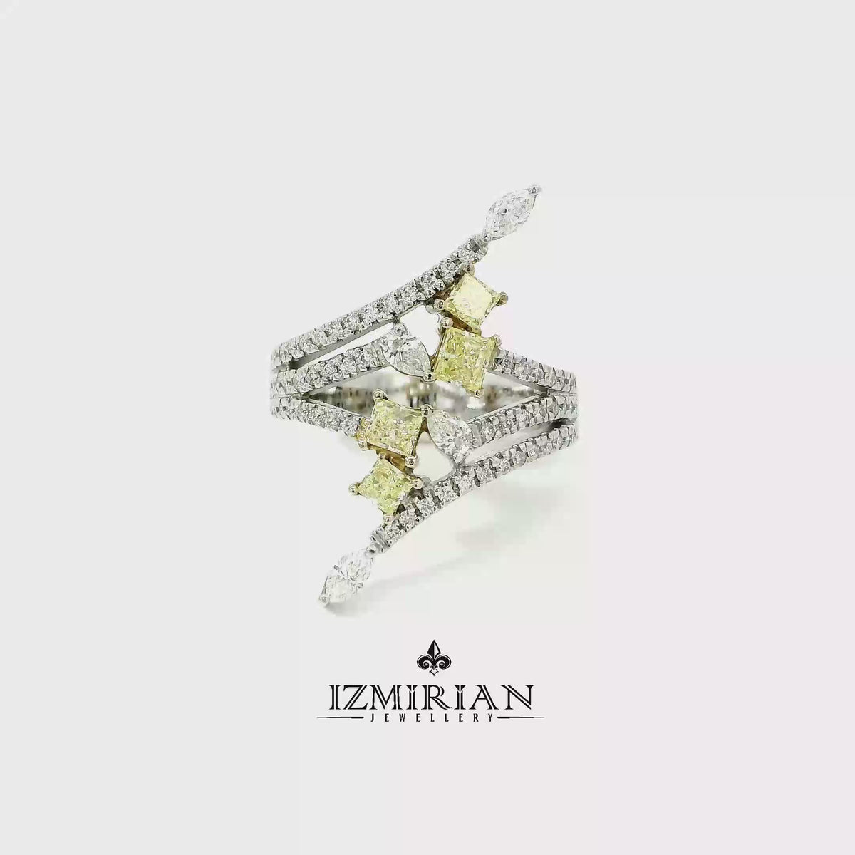 Yellow and white diamond open ring in white gold shown in motion