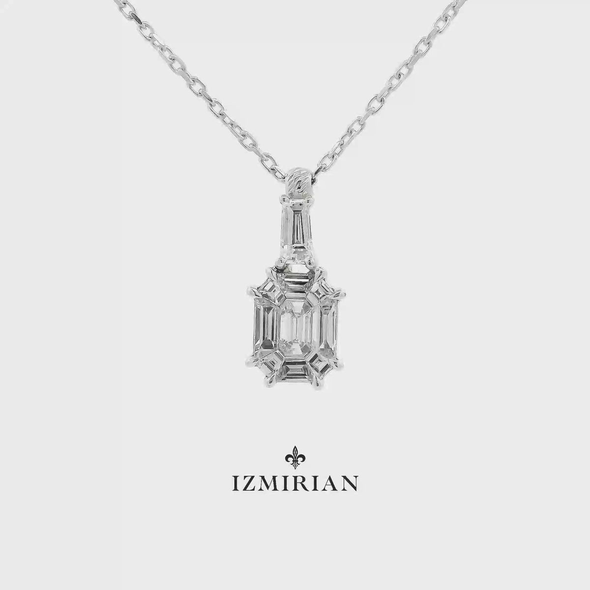 Emerald-cut diamond geometric pendant in white gold shown in motion