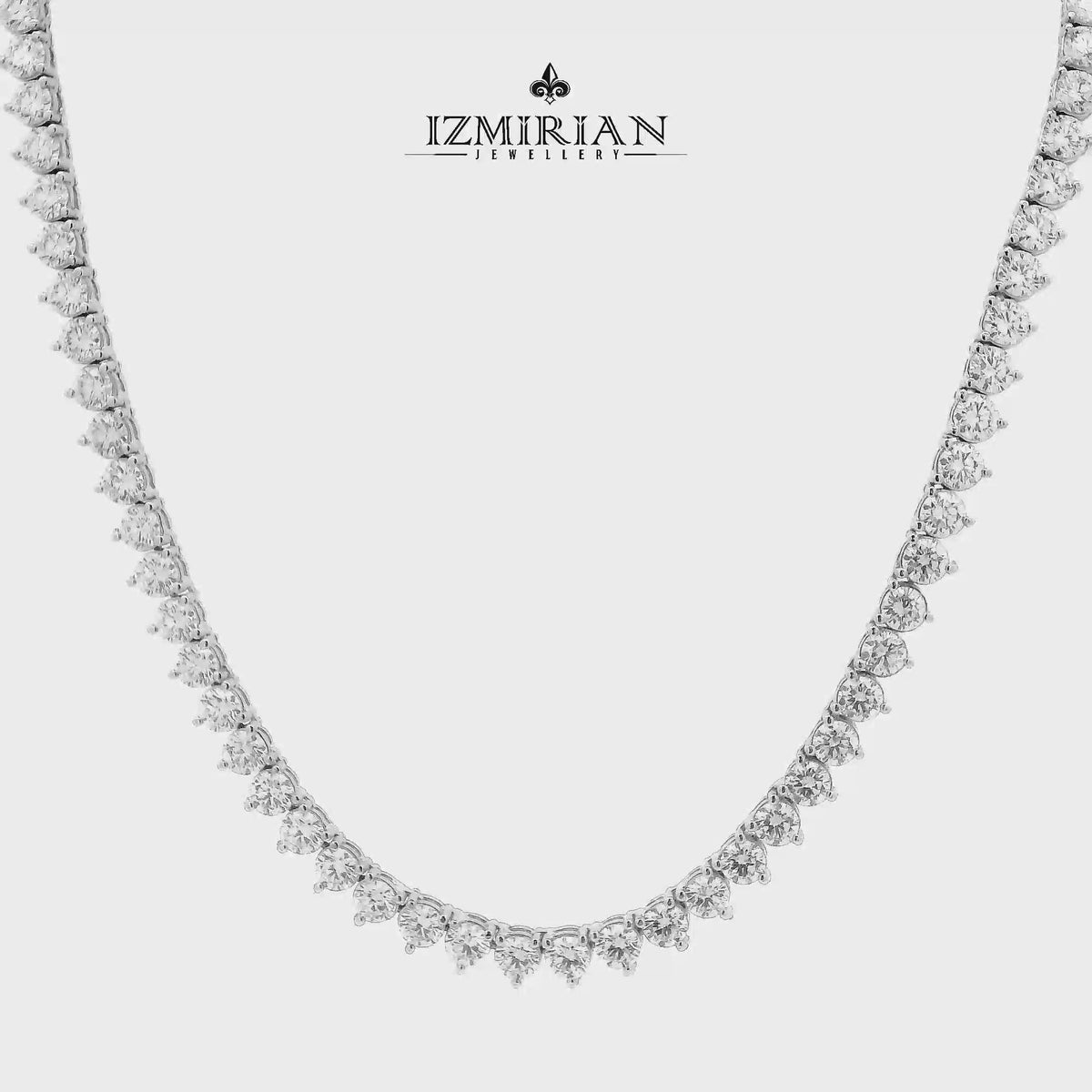 Graduated diamond tennis necklace in white gold shown in motion