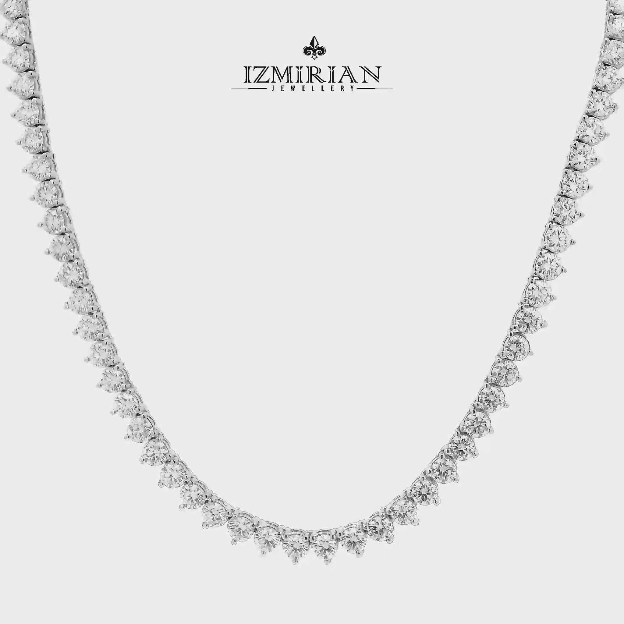 Graduated diamond tennis necklace in white gold shown in motion