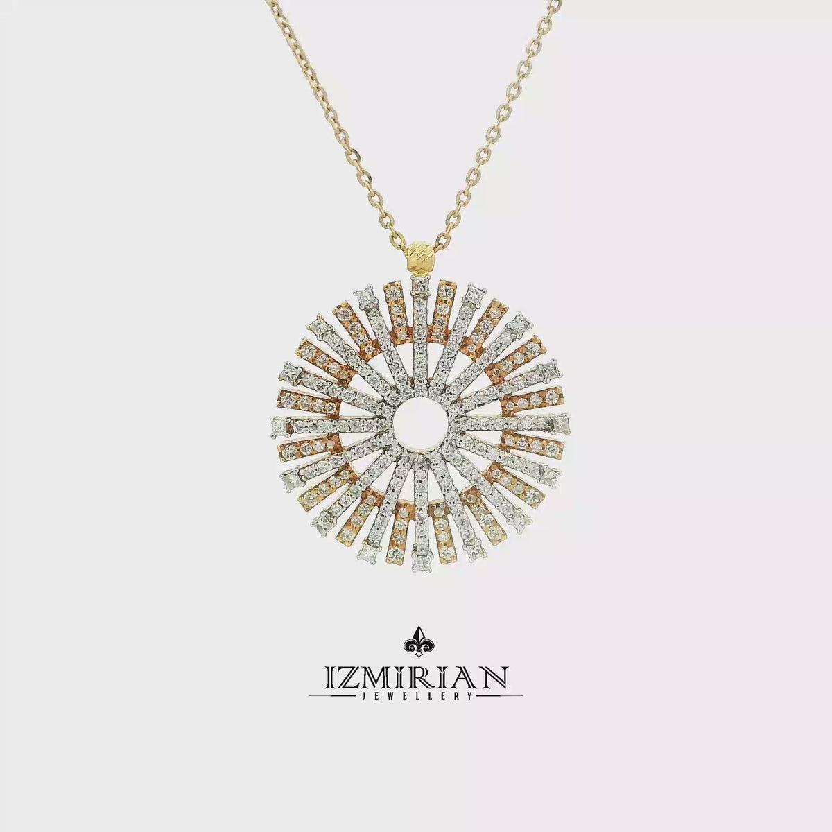 Diamond sunray pendant in yellow and white gold shown in motion