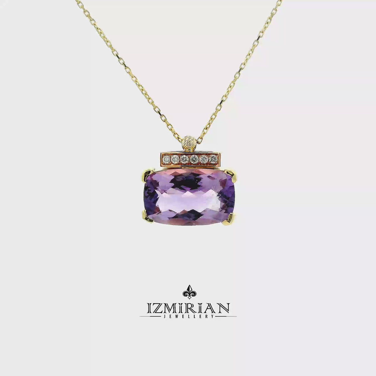 Amethyst and diamond bar pendant in yellow gold shown in motion