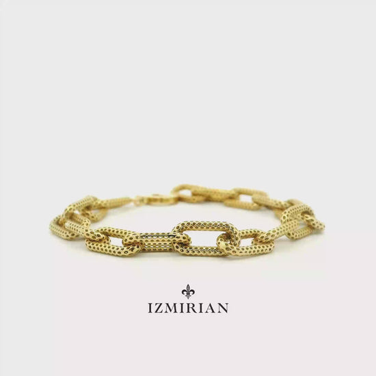 Textured yellow gold link bracelet shown in motion