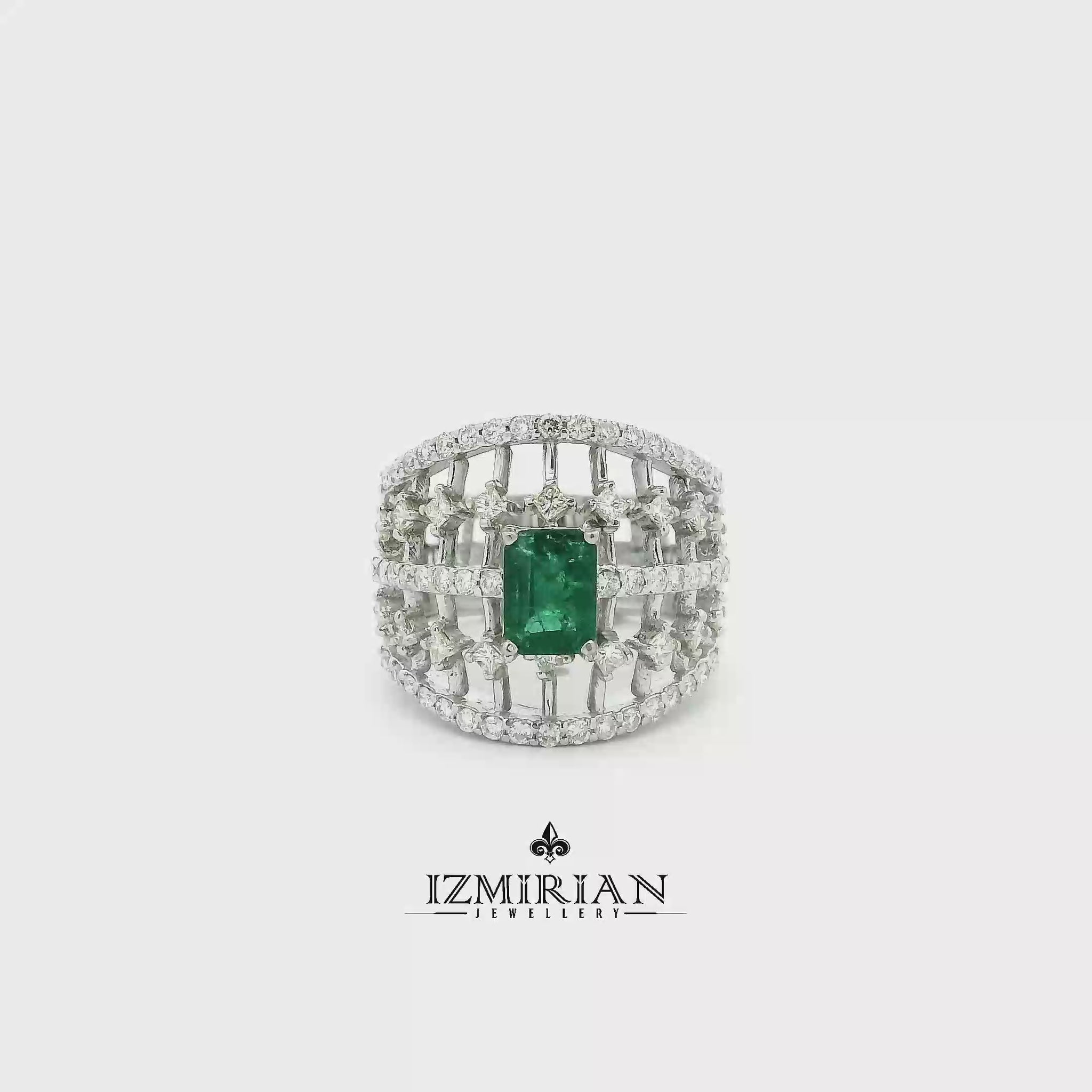 Emerald cage statement ring in white gold shown in motion