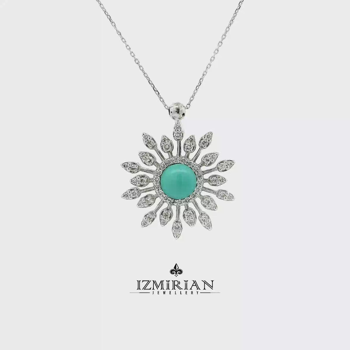 Turquoise and diamond sunburst pendant in white gold shown in motion