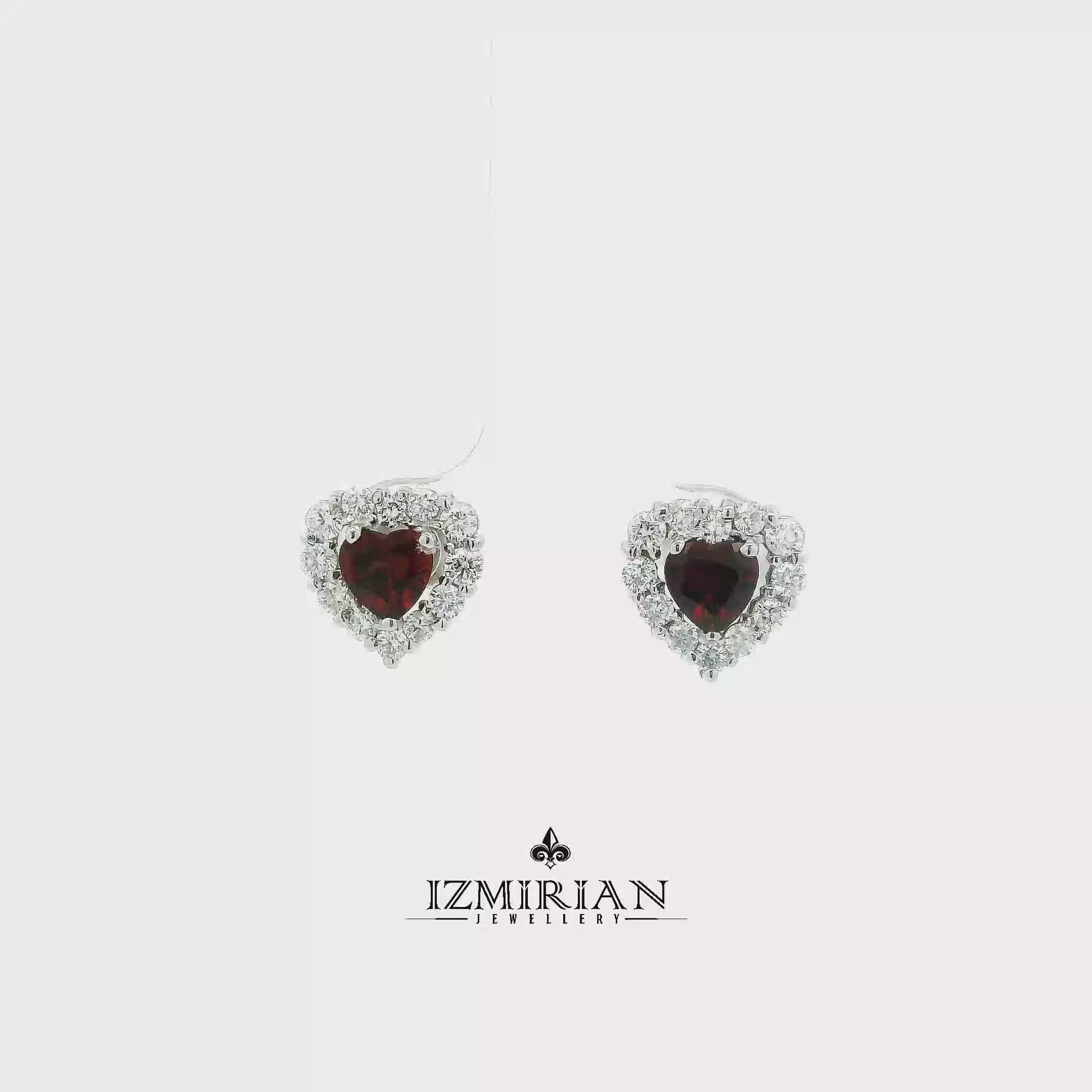 Heart garnet and diamond stud earrings in white gold shown in motion