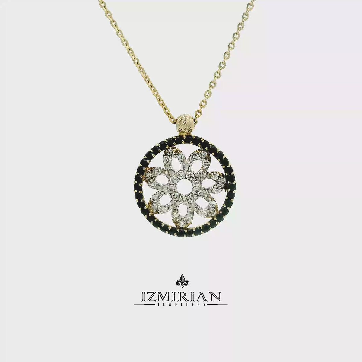 Yellow gold floral circle pendant with black and white diamonds shown in motion