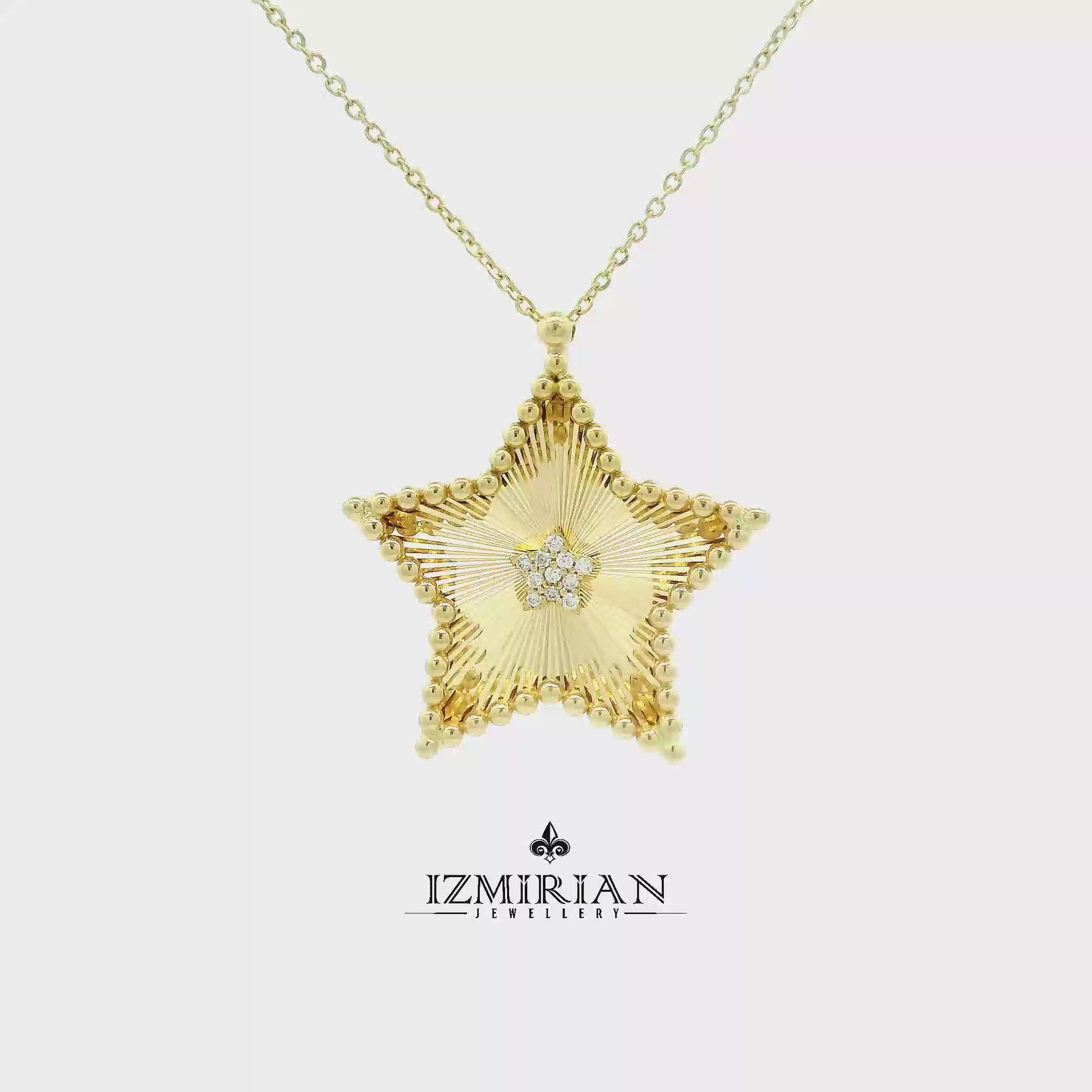 Diamond star pendant necklace in yellow gold shown in motion