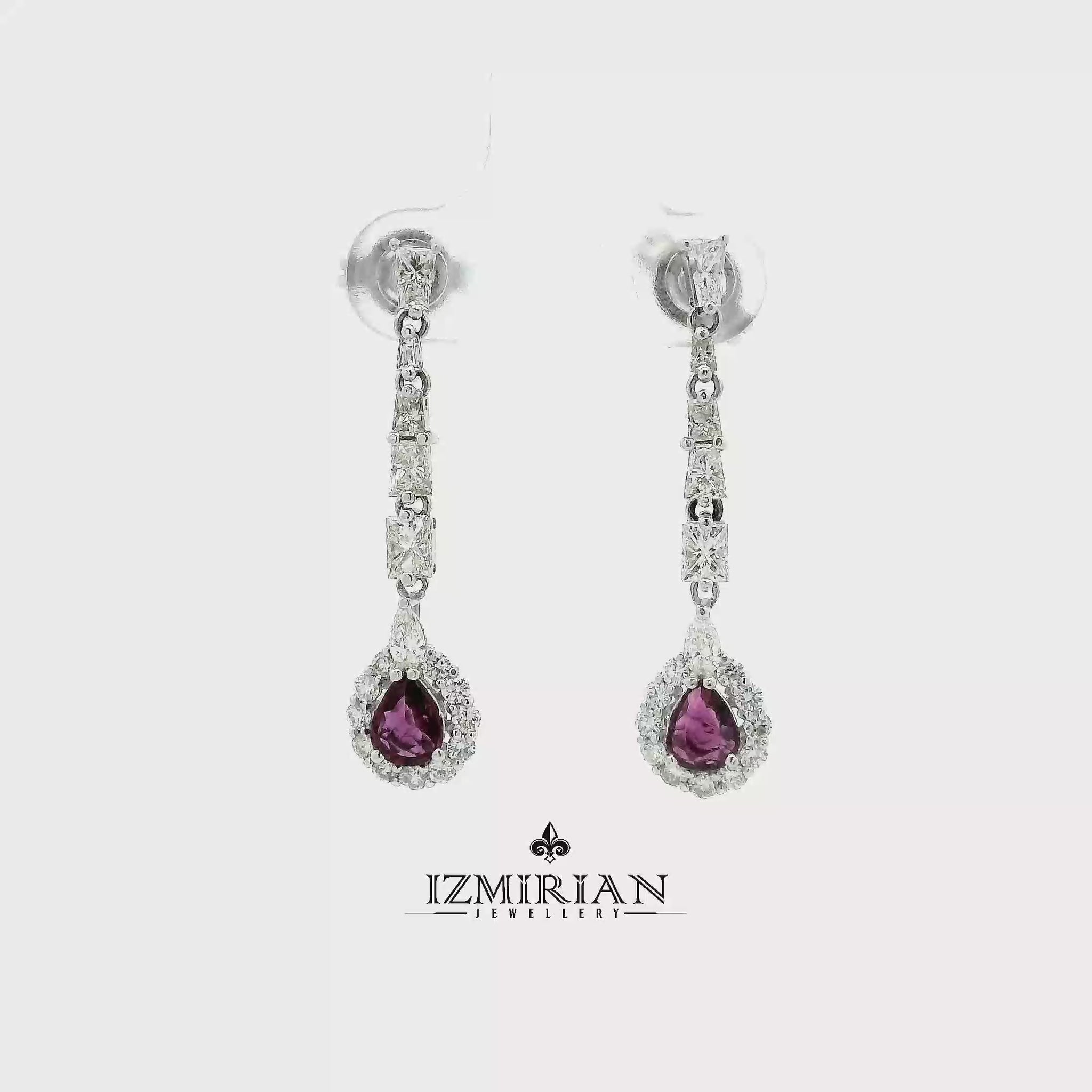Pink sapphire and diamond drop earrings in white gold shown in motion
