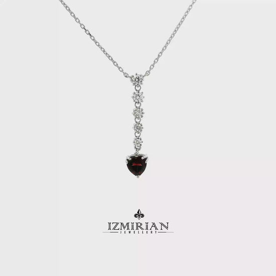 Heart garnet and diamond drop necklace in white gold shown in motion