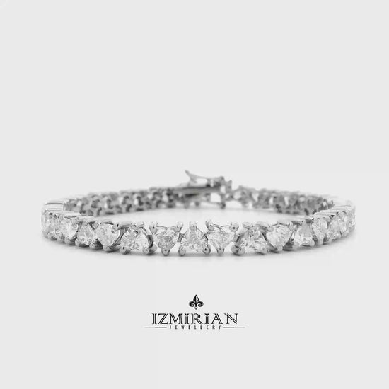 Pear and round diamond tennis bracelet in white gold shown in motion