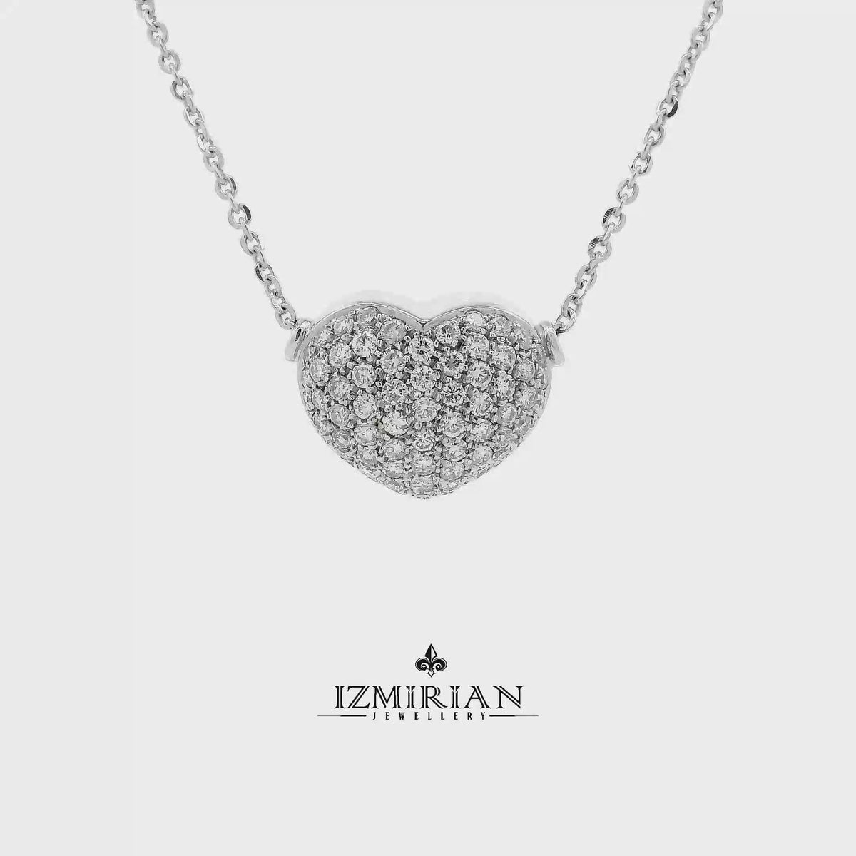 Pavé diamond heart necklace in white gold shown in motion