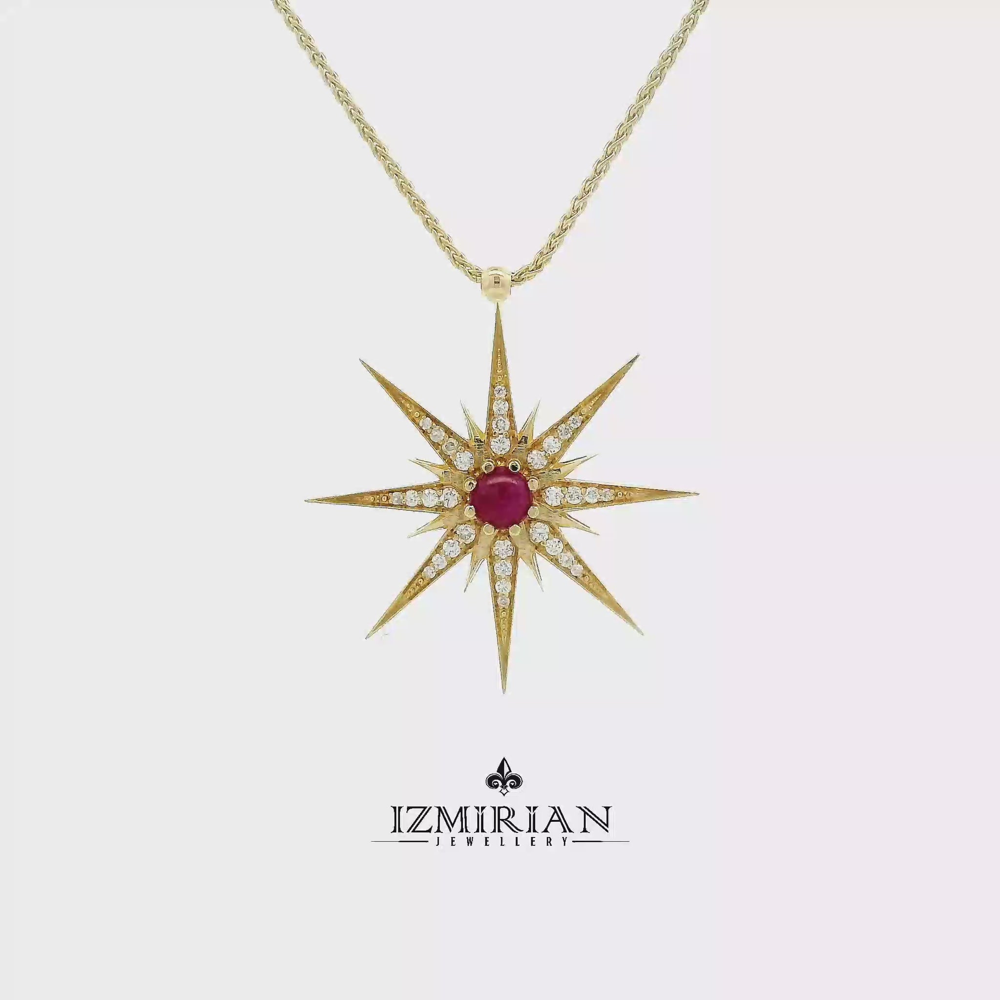 Ruby starburst diamond pendant in yellow gold shown in motion