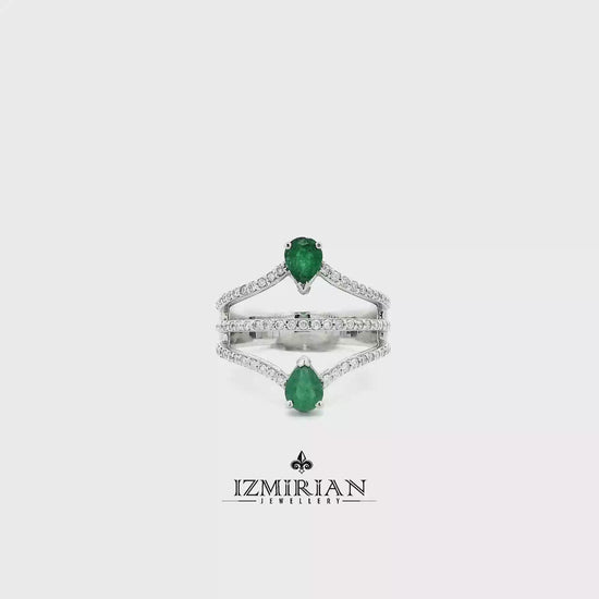 White gold ring with pear-shaped emeralds and diamond bands shown in motion