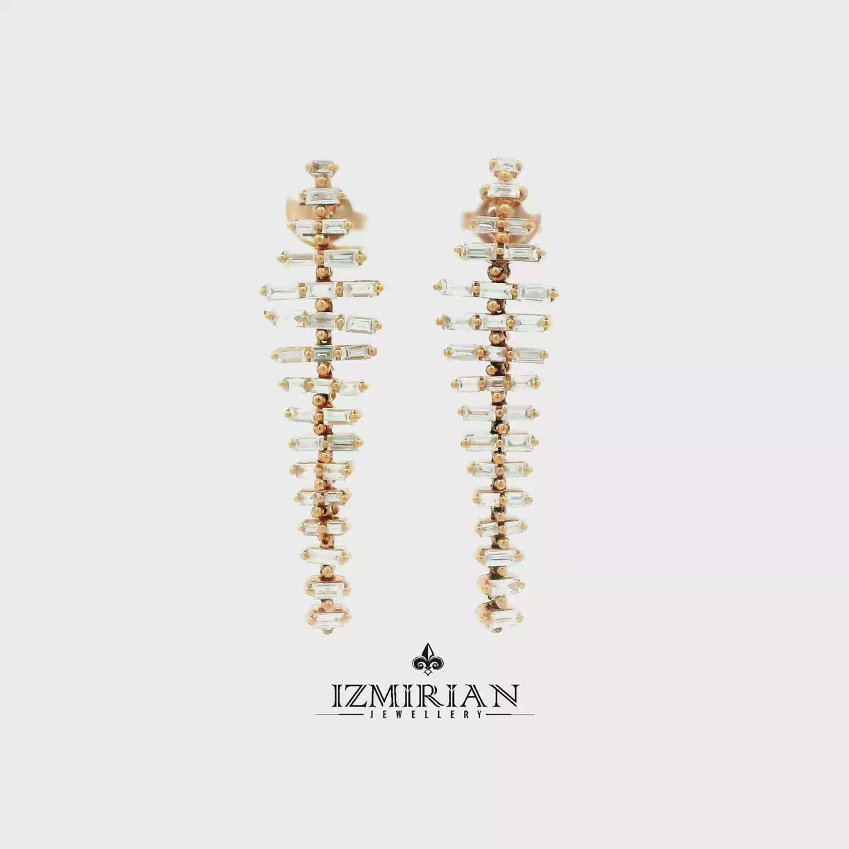 Baguette diamond drop earrings in rose gold shown in motion