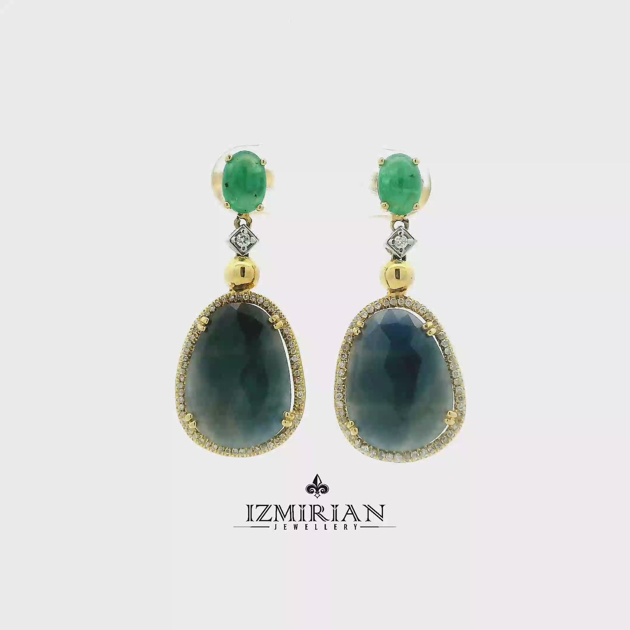 Emerald and blue sapphire drop earrings in yellow gold shown in motion