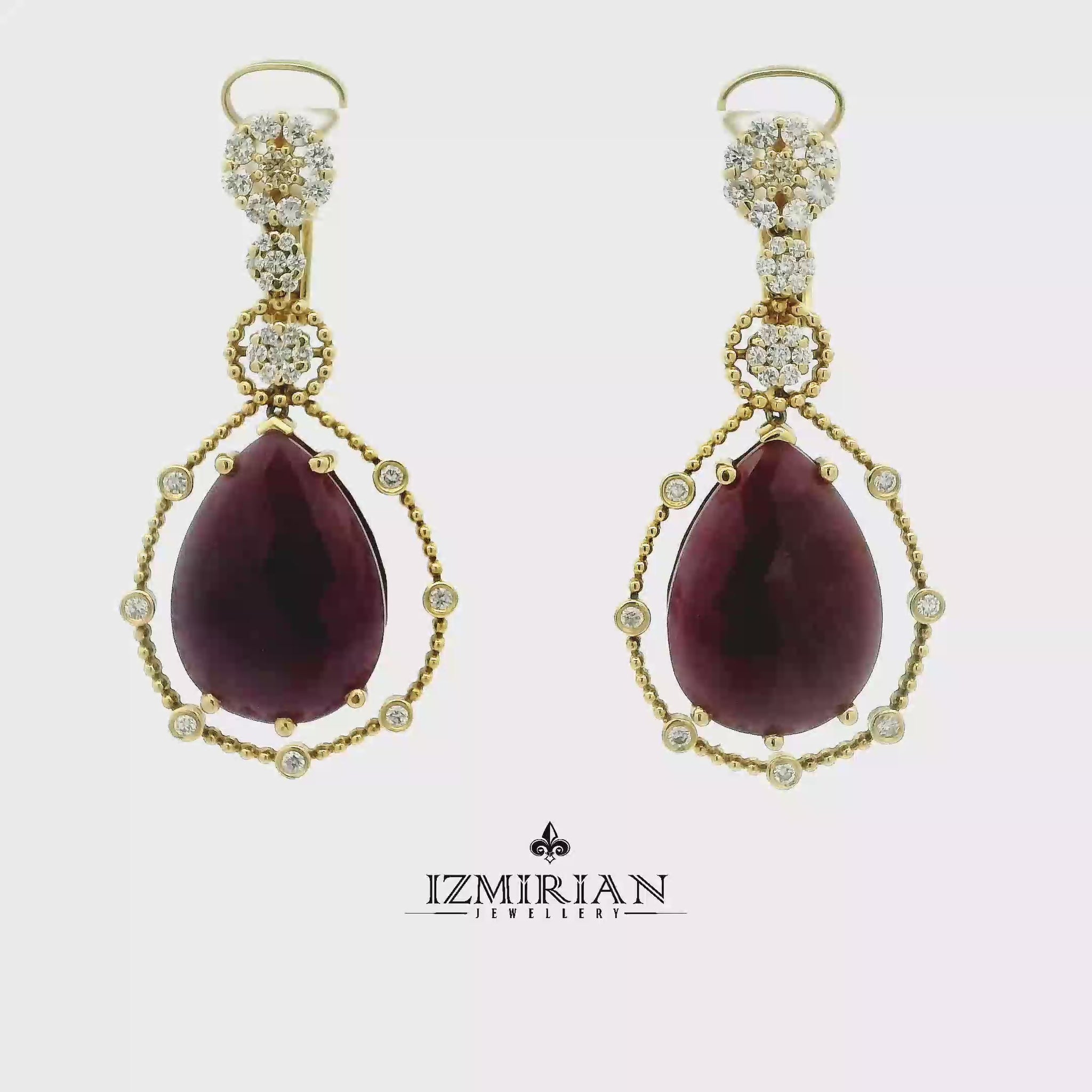 Ruby and diamond drop earrings in yellow gold shown in motion