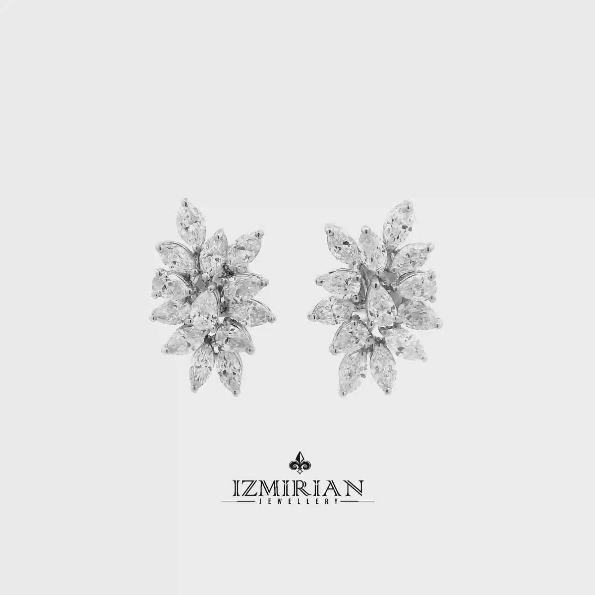 Marquise diamond cluster stud earrings in white gold shown in motion