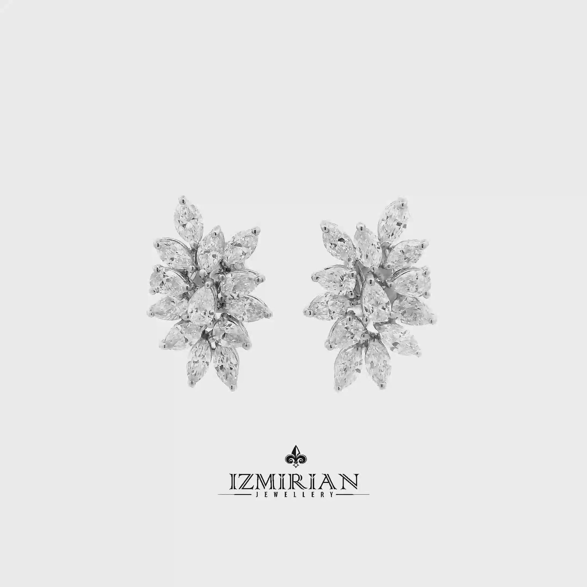 Marquise diamond cluster stud earrings in white gold shown in motion