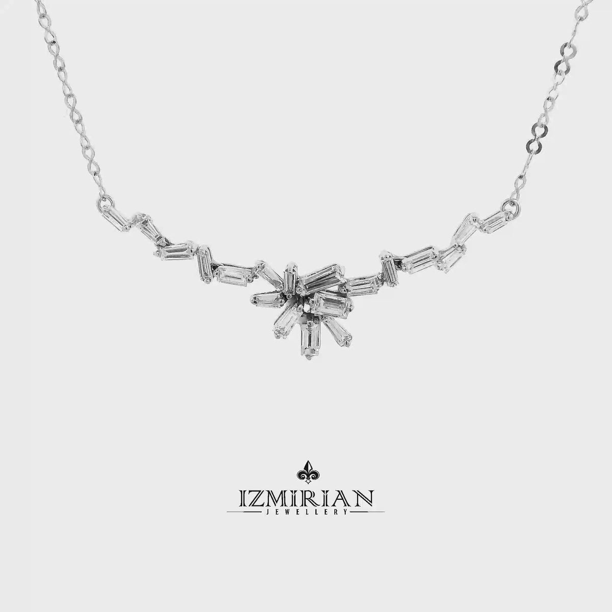 Baguette diamond star necklace in white gold shown in motion