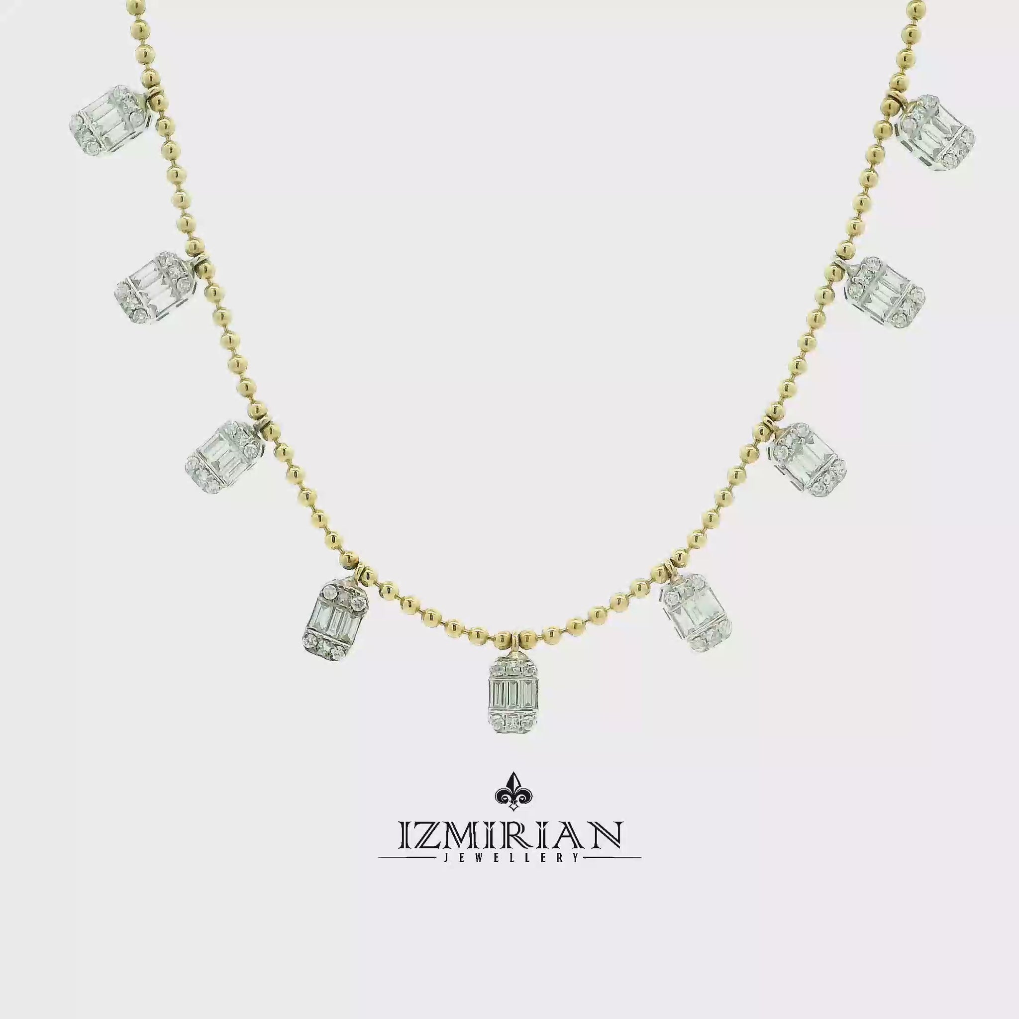 Baguette diamond charm necklace in yellow gold shown in motion