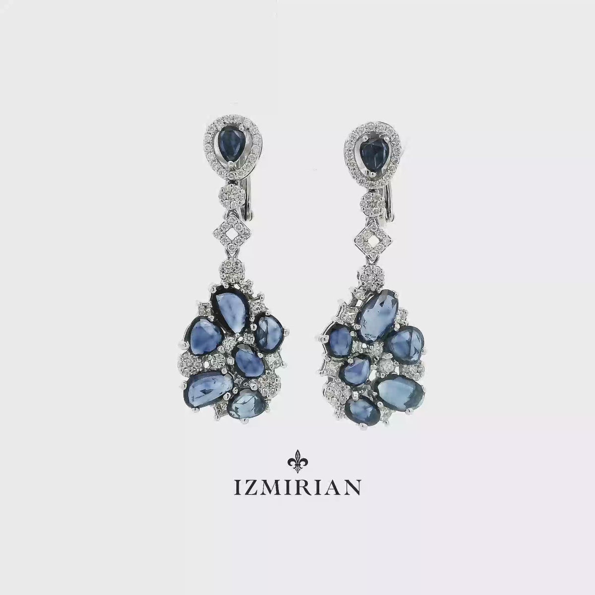 Sapphire cluster drop earrings in white gold shown in motion