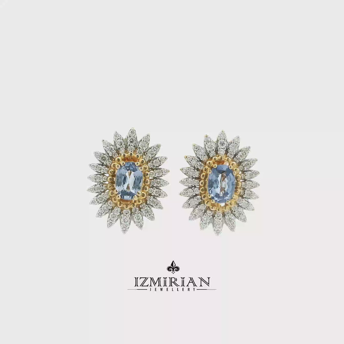Two-tone sapphire and diamond sunburst earrings shown in motion