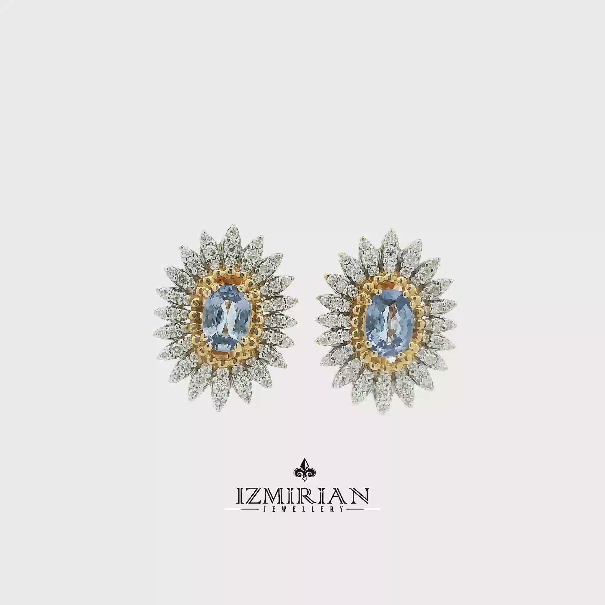 Two-tone sapphire and diamond sunburst earrings shown in motion