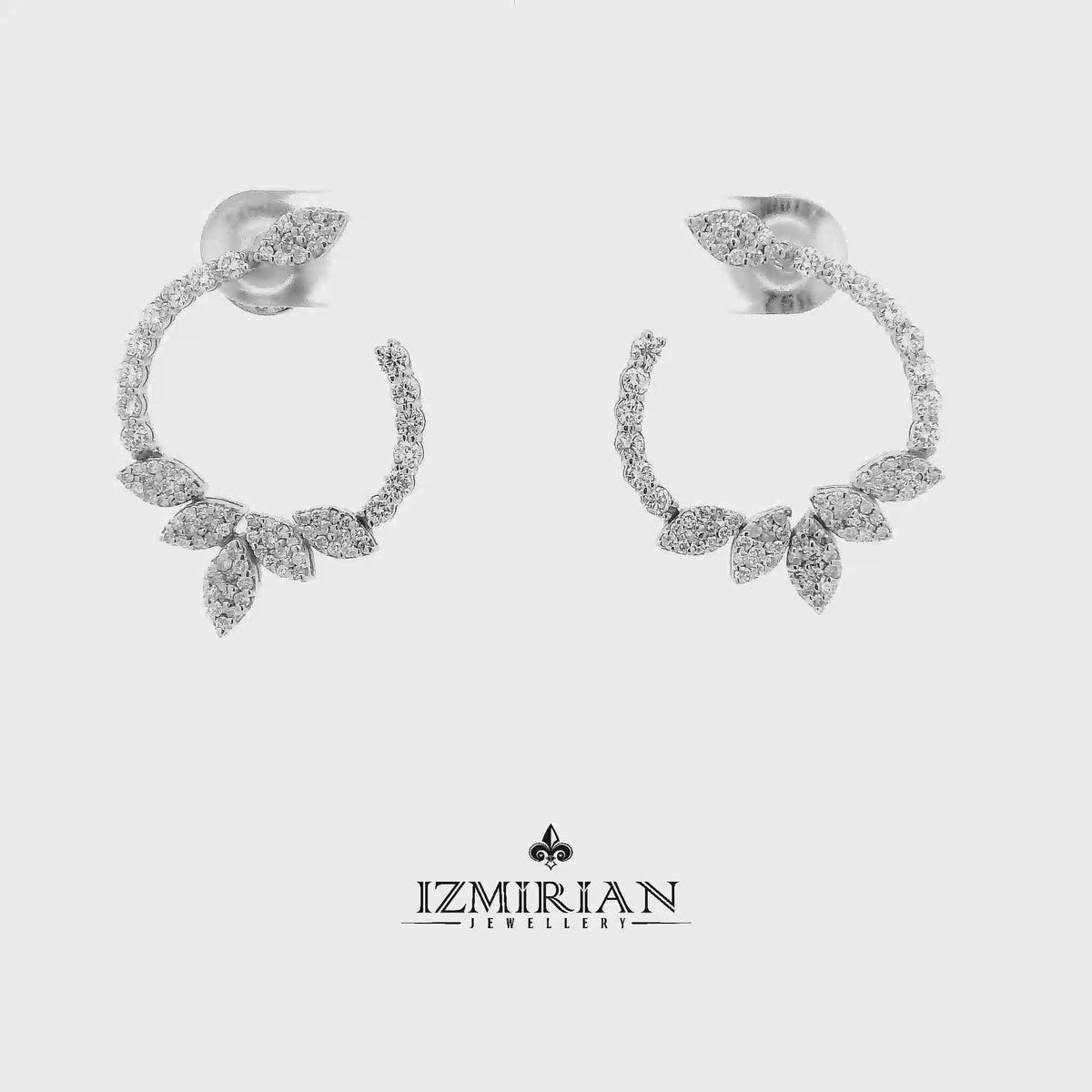 Diamond leaf hoop earrings in white gold shown in motion