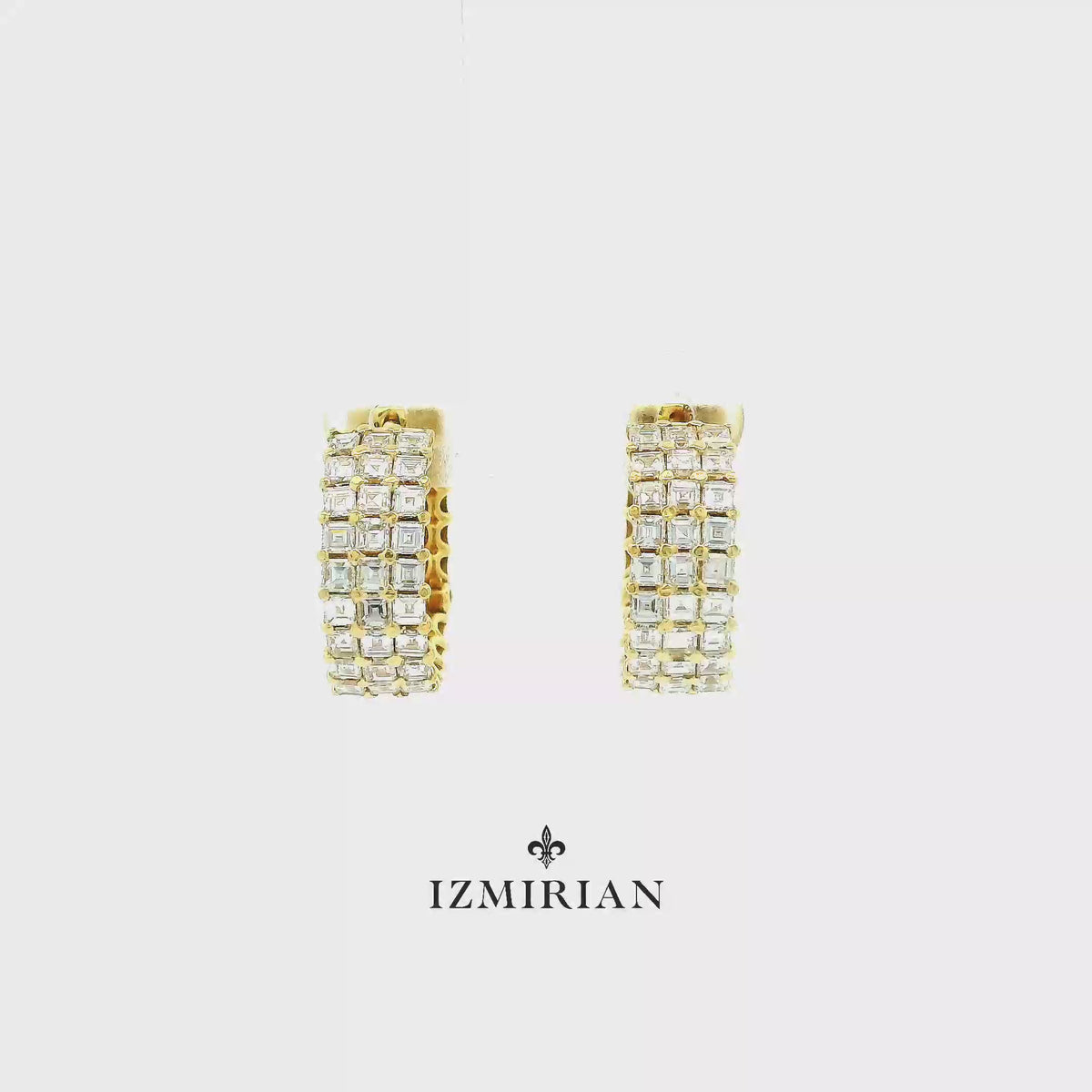 Yellow gold diamond huggie hoop earrings shown in motion