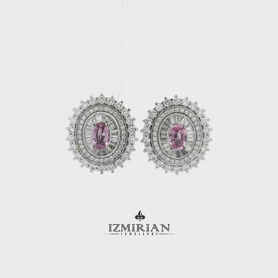 Pink sapphire and diamond halo earrings in white gold shown in motion